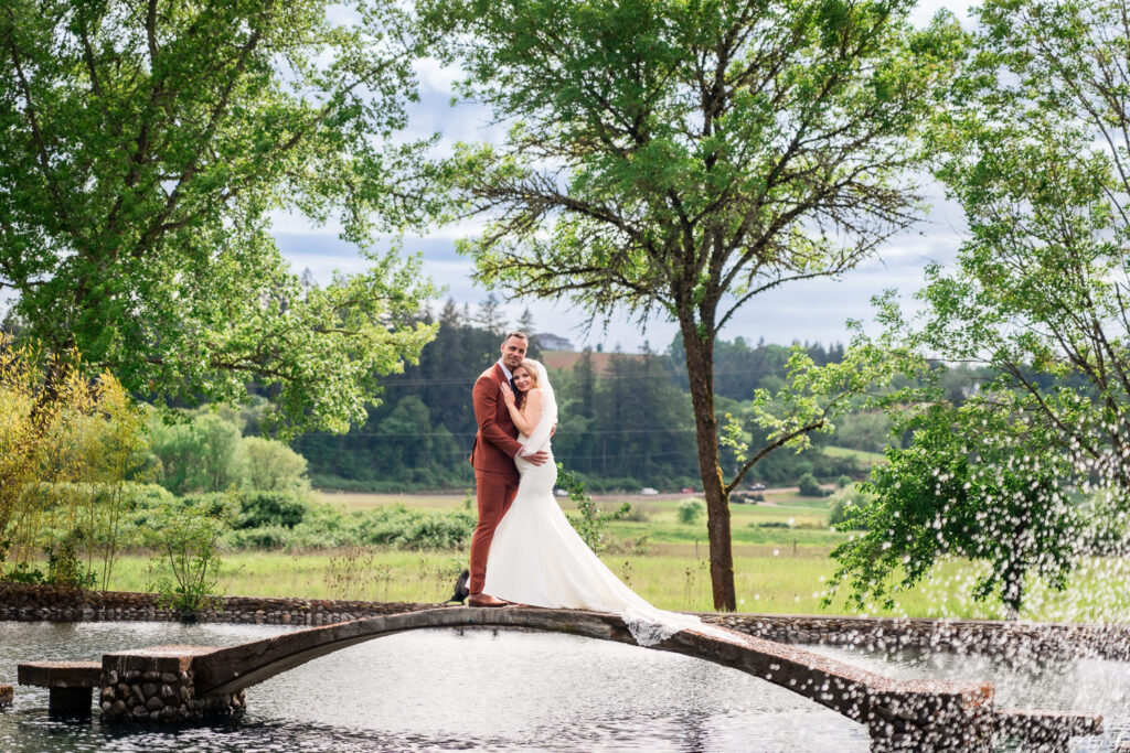 Water Oasis Wedding Portrait of Bride and Groom on the bridge over the pond