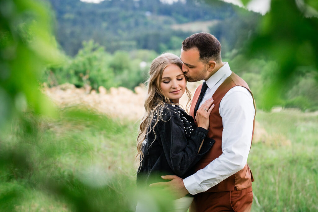 Water Oasis Wedding Portrait of Bride and Groom in the meadow with wine country hills in distance